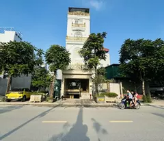 house for sale on co linh street, wide sidewalk, flower garden view, 2 container trucks avoiding each other, office business